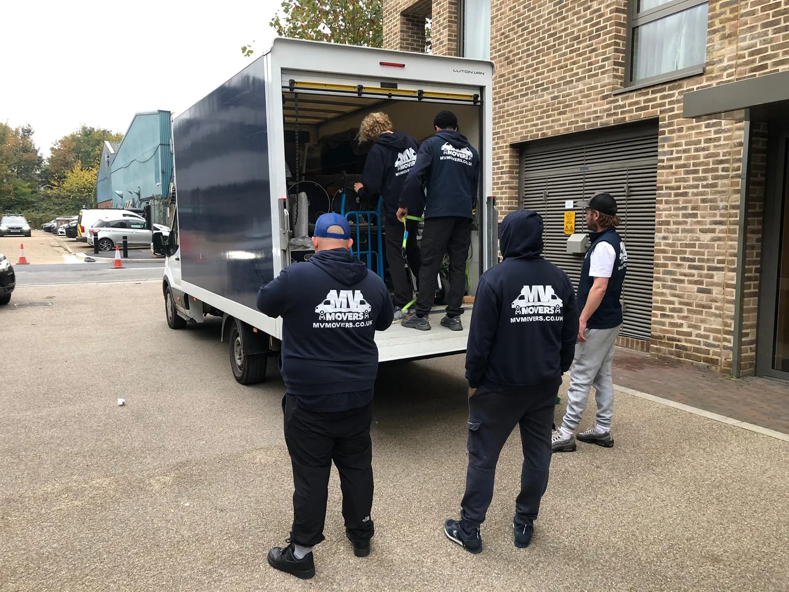 MV Movers crew loading a van outside a West London apartment block during a flat clearance